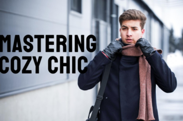 A person with their face obscured by a pixelated block stands outside near a building, wearing a winter coat and scarf, with the phrase “MASTERING COZY CHIC” overlaid in large white letters.